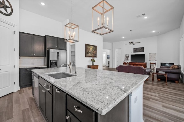 1404 Scenic Oaks Dr, Georgetown, TX 78628 - kitchen featuring stainless steel fridge, a ceiling fan, wood finished floors, recessed lighting, and pendant lighting