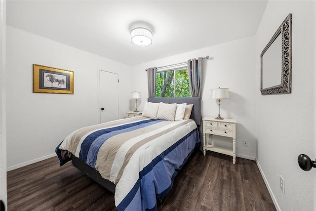 7801 Elderberry Dr, Austin, TX 78745 - bedroom featuring baseboards and dark wood-type flooring