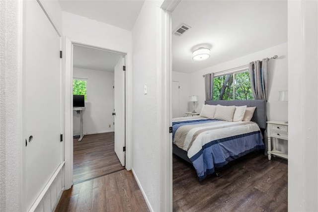 7801 Elderberry Dr, Austin, TX 78745 - bedroom featuring dark wood-style flooring and baseboards