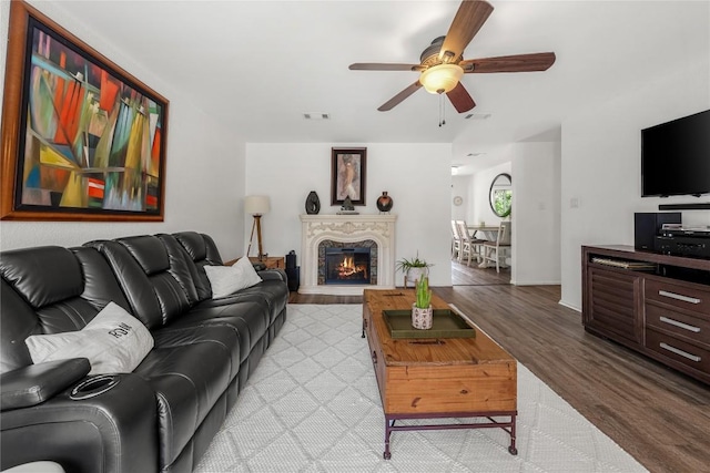 7801 Elderberry Dr, Austin, TX 78745 - living area with a ceiling fan, light wood-style flooring, and a lit fireplace