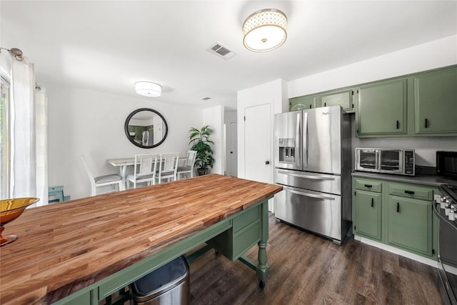 7801 Elderberry Dr, Austin, TX 78745 - kitchen featuring green cabinetry, stainless steel fridge, wood counters, and dark wood-style flooring