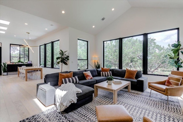 8009 Golden Oaks Ln, Austin, TX 78737 - living room with recessed lighting, light wood finished floors, high vaulted ceiling, and a skylight