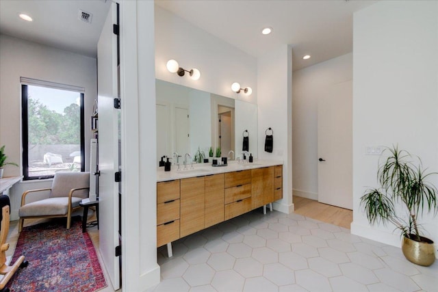 8009 Golden Oaks Ln, Austin, TX 78737 - bathroom featuring double vanity, tile patterned floors, and recessed lighting
