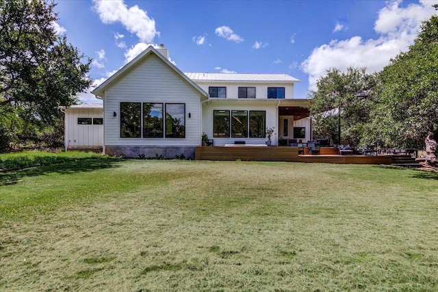 8009 Golden Oaks Ln, Austin, TX 78737 - rear view of house featuring a chimney, a wooden deck, a lawn, and a metal roof