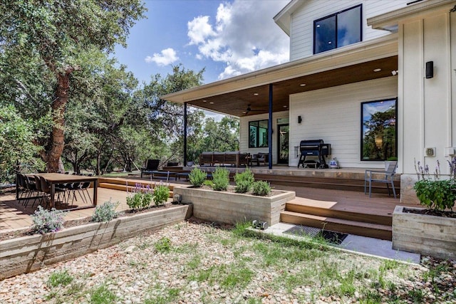 8009 Golden Oaks Ln, Austin, TX 78737 - wooden deck with a ceiling fan and outdoor dining area