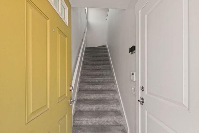 1601 Miriam Ave Unit 216, Austin, TX 78702 - staircase featuring baseboards and carpet