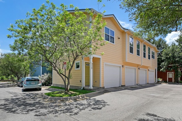 1601 Miriam Ave Unit 216, Austin, TX 78702 - view of property featuring an attached garage and asphalt driveway