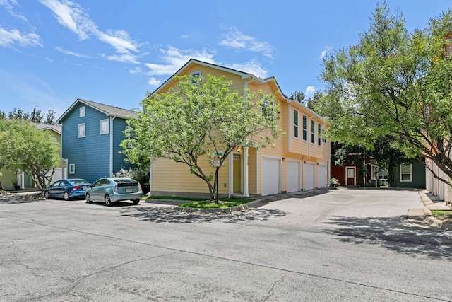 1601 Miriam Ave Unit 216, Austin, TX 78702 - view of front of house featuring an attached garage and asphalt driveway