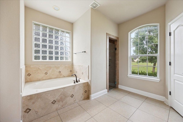 144 Escondido Dr, Del Valle, TX 78617 - full bathroom featuring a bath, tile patterned flooring, and a stall shower