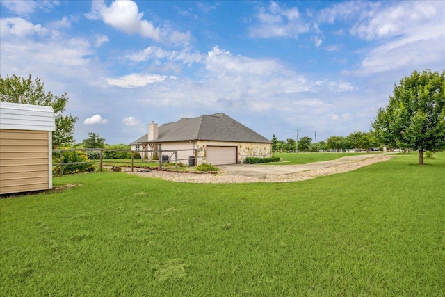 144 Escondido Dr, Del Valle, TX 78617 - view of green lawn featuring driveway and a garage