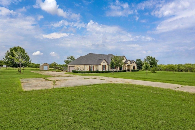 144 Escondido Dr, Del Valle, TX 78617 - french provincial home featuring driveway, a front yard, a garage, and a storage unit