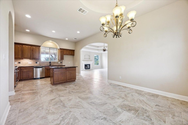 144 Escondido Dr, Del Valle, TX 78617 - kitchen with arched walkways, stainless steel dishwasher, open floor plan, a chandelier, and dark countertops