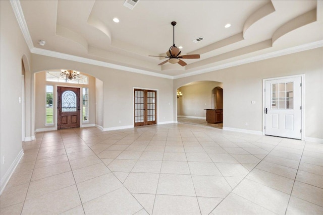 144 Escondido Dr, Del Valle, TX 78617 - foyer entrance featuring arched walkways, a tray ceiling, a chandelier, ceiling fan, and crown molding