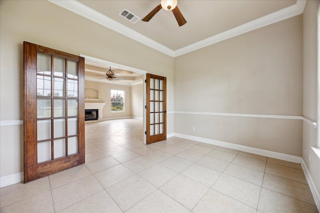 144 Escondido Dr, Del Valle, TX 78617 - empty room with ceiling fan, crown molding, a fireplace with raised hearth, and light tile patterned floors