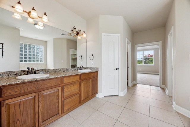 144 Escondido Dr, Del Valle, TX 78617 - bathroom with double vanity and tile patterned flooring