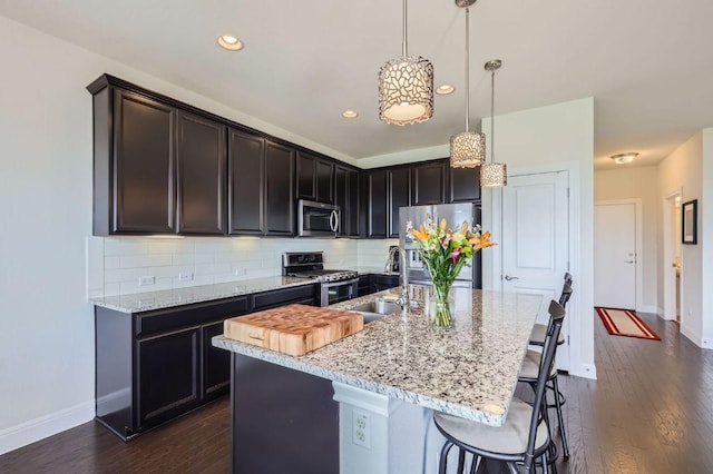 3025 Lions Tail St, Austin, TX 78728 - kitchen with stainless steel appliances, tasteful backsplash, a kitchen breakfast bar, dark wood finished floors, and recessed lighting