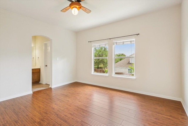 102 Country View Way, Cedar Park, TX 78613 - empty room with arched walkways, ceiling fan, and wood finished floors