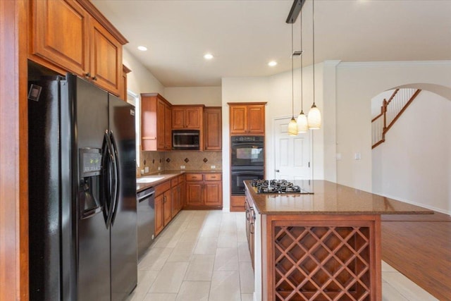 102 Country View Way, Cedar Park, TX 78613 - kitchen with black appliances, arched walkways, brown cabinets, tasteful backsplash, and dark stone countertops