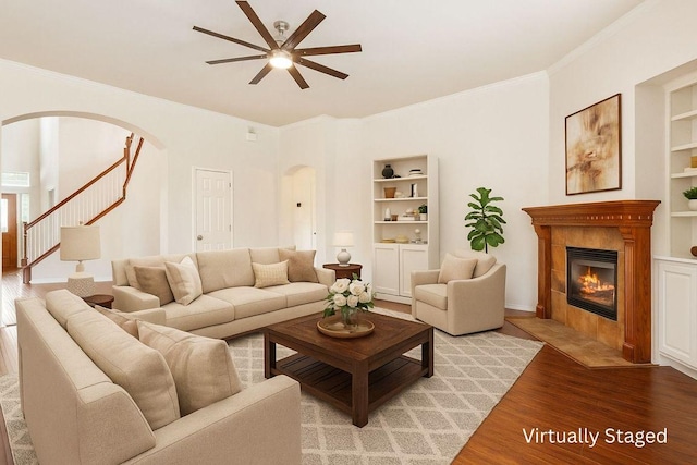 102 Country View Way, Cedar Park, TX 78613 - living area with arched walkways, built in features, ceiling fan, light wood-style floors, and crown molding