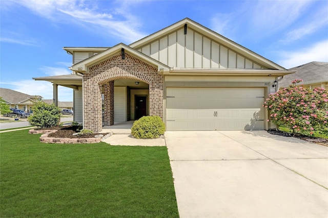 201 Garcitas Creek Ln, Hutto, TX 78634 - view of front of property featuring board and batten siding, brick siding, concrete driveway, a front yard, and an attached garage