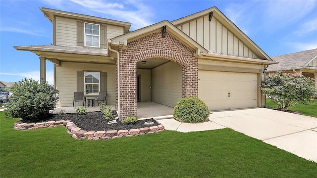 201 Garcitas Creek Ln, Hutto, TX 78634 - view of front of property featuring board and batten siding, a garage, brick siding, a front lawn, and driveway