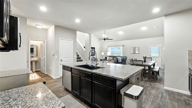 201 Garcitas Creek Ln, Hutto, TX 78634 - kitchen featuring dishwasher, dark cabinetry, dark wood-type flooring, recessed lighting, and ceiling fan