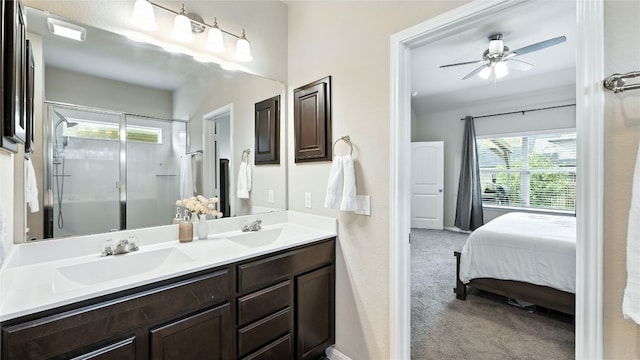 201 Garcitas Creek Ln, Hutto, TX 78634 - ensuite bathroom with double vanity, a stall shower, and a ceiling fan