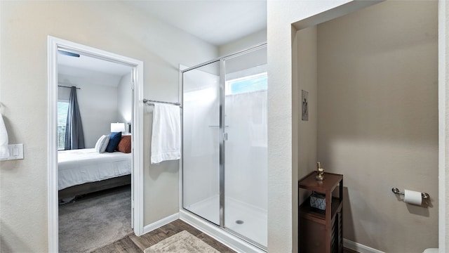 201 Garcitas Creek Ln, Hutto, TX 78634 - ensuite bathroom with wood finished floors, a stall shower, and plenty of natural light