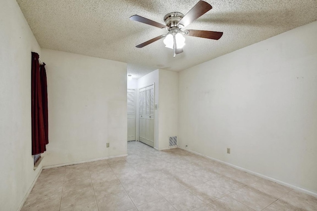 7546 Leafy Hollow Ct, Live Oak, TX 78233 - unfurnished room featuring a textured ceiling, ceiling fan, and light tile patterned floors