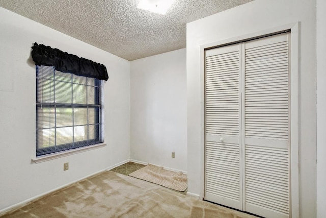 7546 Leafy Hollow Ct, Live Oak, TX 78233 - unfurnished bedroom featuring a closet, a textured ceiling, and carpet flooring