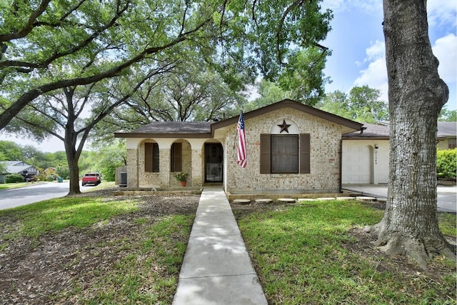 7546 Leafy Hollow Ct, Live Oak, TX 78233 - view of front of home featuring a garage, brick siding, and a shingled roof
