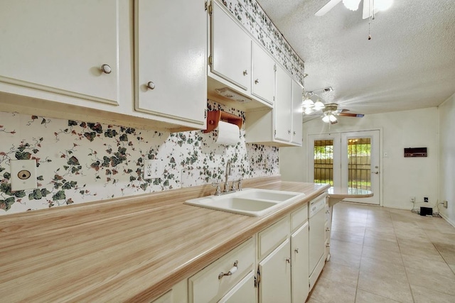7546 Leafy Hollow Ct, Live Oak, TX 78233 - kitchen featuring a ceiling fan, a textured ceiling, light countertops, light tile patterned flooring, and white cabinets