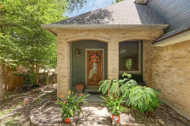 1912 Gaylord Dr, Austin, TX 78728 - view of exterior entry featuring a shingled roof and brick siding