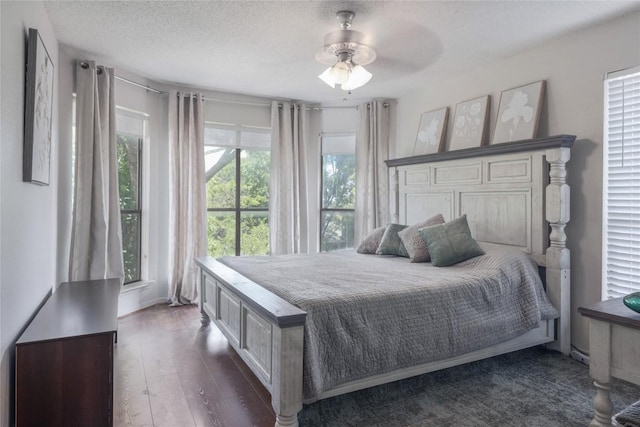 1912 Gaylord Dr, Austin, TX 78728 - bedroom featuring dark wood-type flooring, a textured ceiling, and a ceiling fan