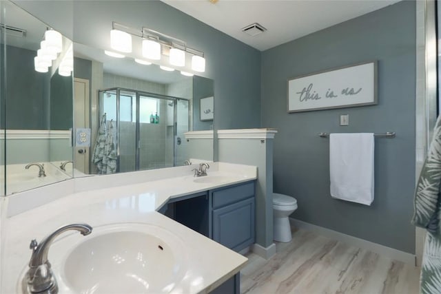 1912 Gaylord Dr, Austin, TX 78728 - bathroom featuring a stall shower, double vanity, and wood finished floors