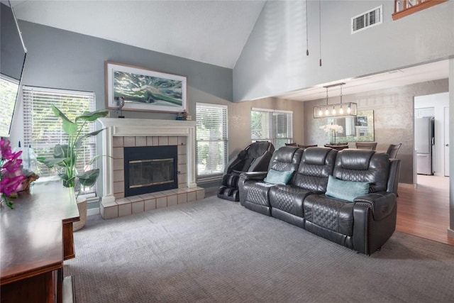 1912 Gaylord Dr, Austin, TX 78728 - carpeted living room featuring high vaulted ceiling, plenty of natural light, a chandelier, and a fireplace