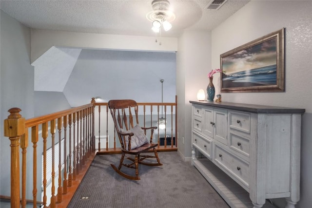 1912 Gaylord Dr, Austin, TX 78728 - living area featuring a ceiling fan, a textured ceiling, carpet floors, and an upstairs landing