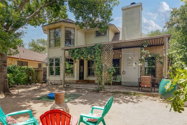 1912 Gaylord Dr, Austin, TX 78728 - rear view of house with a patio, a chimney, and roof with shingles