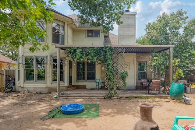 1912 Gaylord Dr, Austin, TX 78728 - back of property featuring a patio, a chimney, and roof with shingles