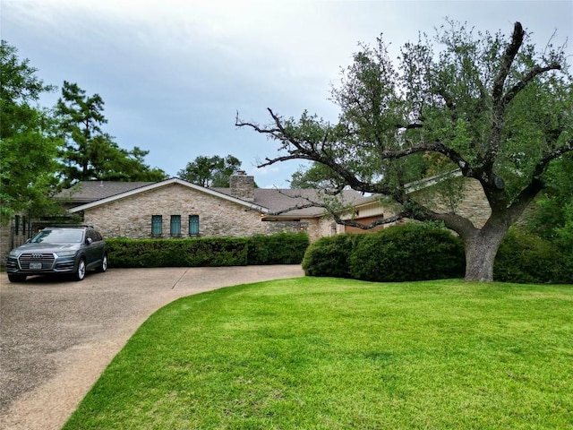921 Vanguard St, Lakeway, TX 78734 - view of front of home featuring a chimney, a front yard, and stone siding