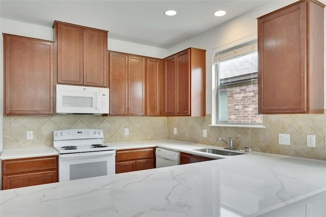 933 Oatmeal Dr, Pflugerville, TX 78660 - kitchen featuring white appliances, light stone counters, backsplash, and recessed lighting