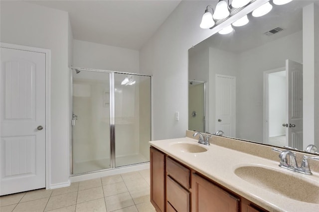 933 Oatmeal Dr, Pflugerville, TX 78660 - bathroom with a shower stall, tile patterned flooring, and double vanity