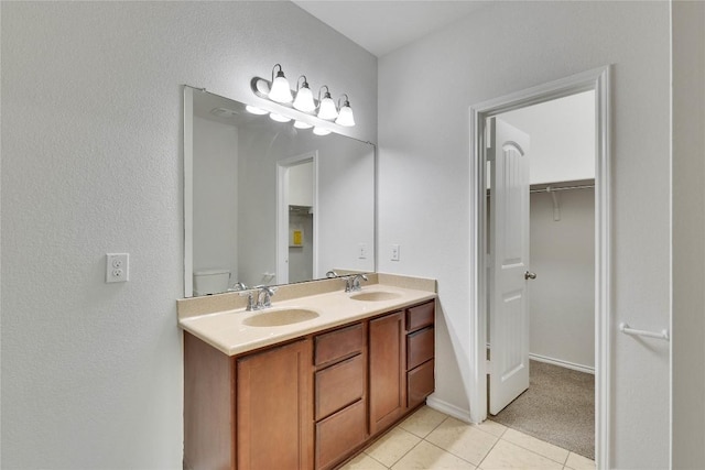 933 Oatmeal Dr, Pflugerville, TX 78660 - bathroom with tile patterned floors, double vanity, and a spacious closet