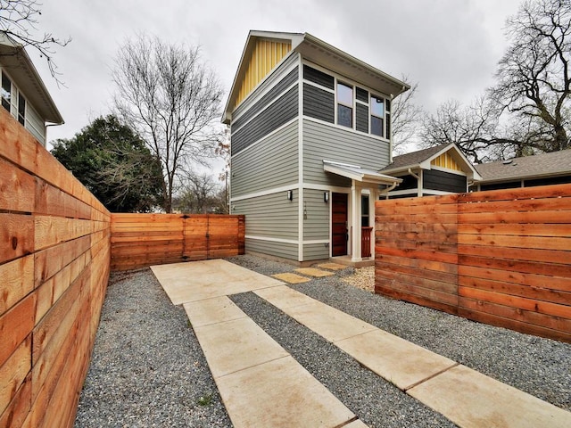720 Pedernales St Unit B, Austin, TX 78702 - view of side of property with a fenced backyard and board and batten siding