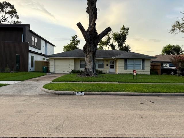 8050 Montridge Dr, Houston, TX 77055 - view of front of property with driveway, an attached garage, and a front lawn