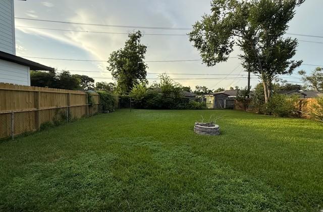 8050 Montridge Dr, Houston, TX 77055 - fenced backyard featuring a fire pit