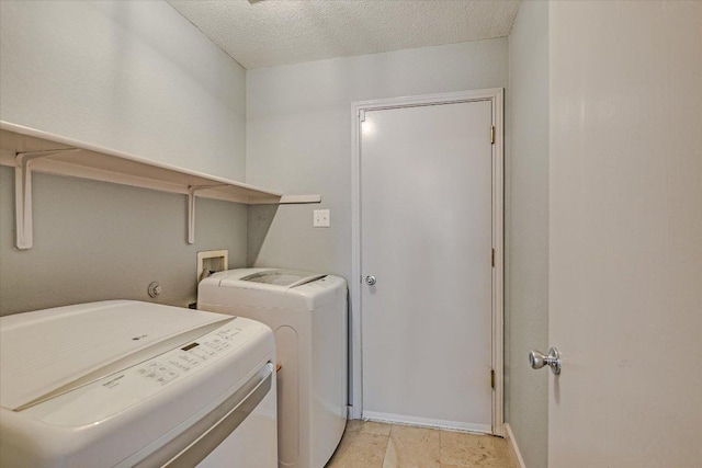 215 Peaceful Haven Way, Hutto, TX 78634 - washroom with separate washer and dryer and a textured ceiling