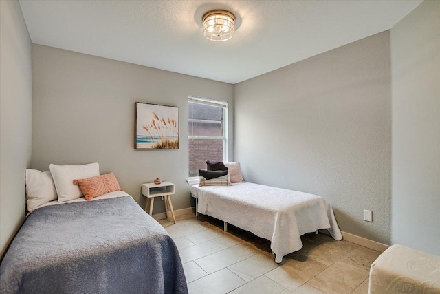 215 Peaceful Haven Way, Hutto, TX 78634 - bedroom featuring baseboards and light tile patterned floors