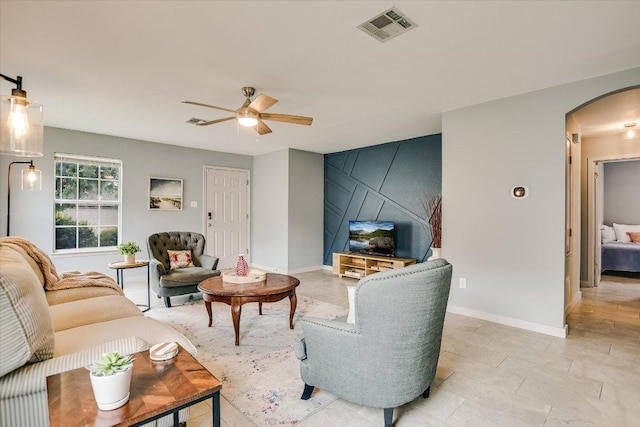 215 Peaceful Haven Way, Hutto, TX 78634 - living room featuring arched walkways and a ceiling fan