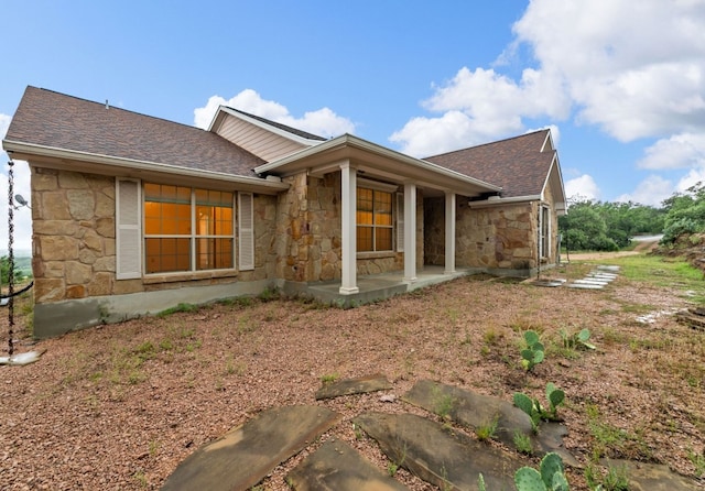 851 Stone Mountain Dr, Marble Falls, TX 78654 - view of home's exterior with stone siding and a shingled roof